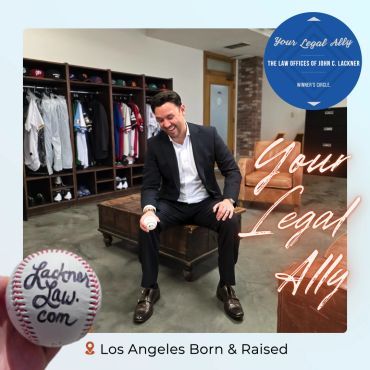 A professional man in a suit holding a baseball in a sports locker room setting.