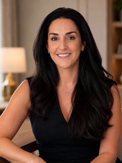 Smiling woman with long dark hair in a black top.