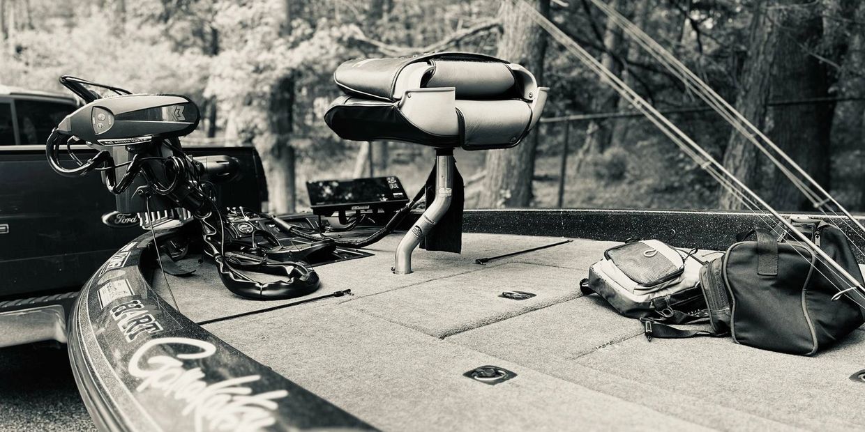 Close-up of a fishing boat deck with equipment and seat.