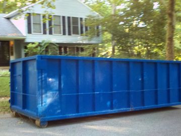30 yard roll off dumpster parked on street for a large residential project