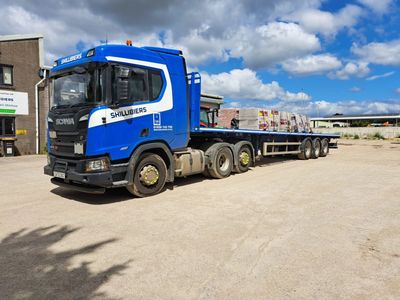 Our flatbed trailer loaded with bricks, ready to deliver to one of our customers.