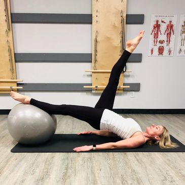 Pilates mat flexibility exercise with large stability ball