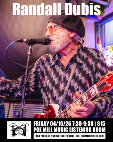 Randall Dubis performing live with guitar and microphone.