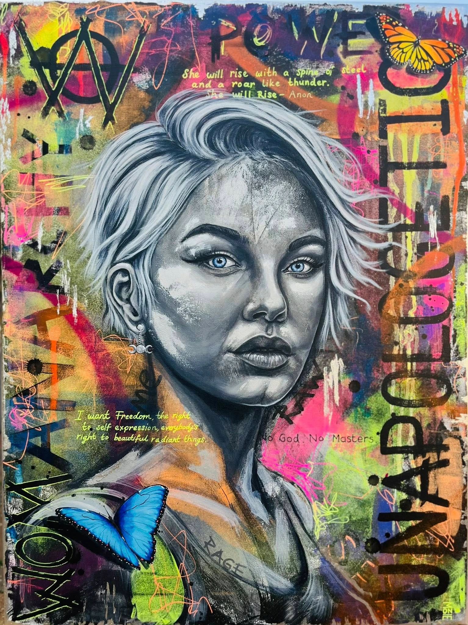 Colorful street art of a woman's portrait with butterflies and empowering words.