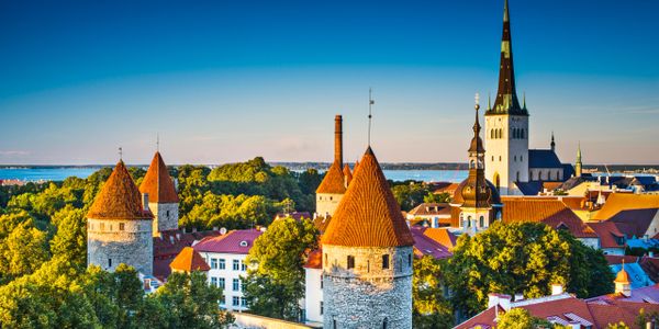 Scenic view of medieval towers and church spires under a clear blue sky.