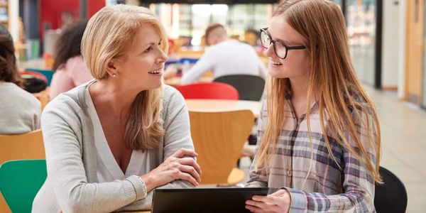 Teacher talking to student to de-escalate a situation in the classroom