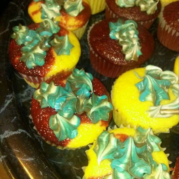 Yellow red velvet cupcakes with blue cream cheese icing 