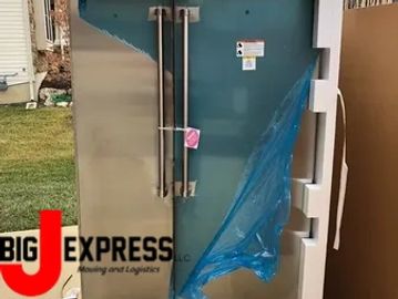 commercial size refrigerator being moved into kitchen in St Charles, MO