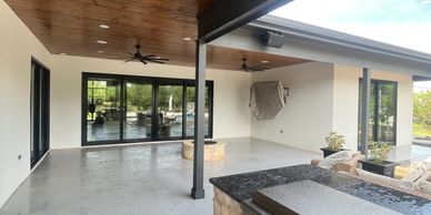 Modern covered patio with ceiling fans and stone accents.