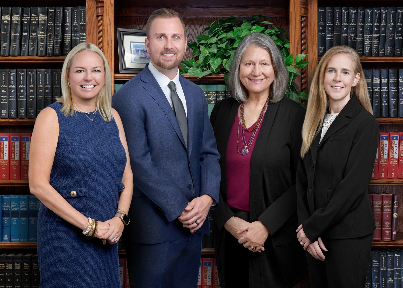Group photo of the 4 attorneys smiling in their professional attire.