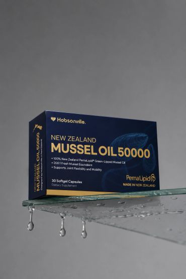 Box of New Zealand Mussel Oil 50000 dietary supplement capsules on a wet glass surface.
