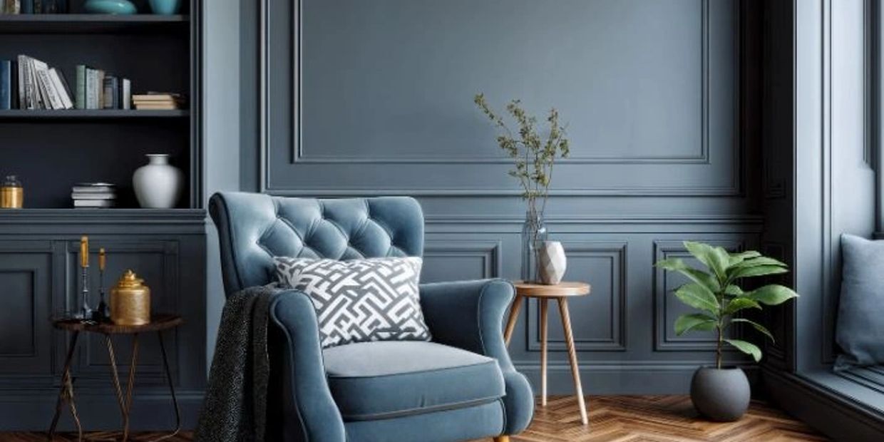 Blue painted room with blue chair and built in bookshelf. 