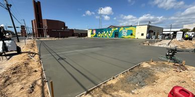 Freshly poured concrete slab drying in an urban construction site.