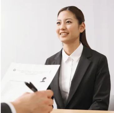 Female employee having identification documents reviewed during an I-9 employment verification appoi