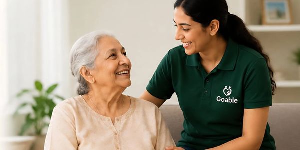 A caregiver warmly interacts with an elderly woman at home.