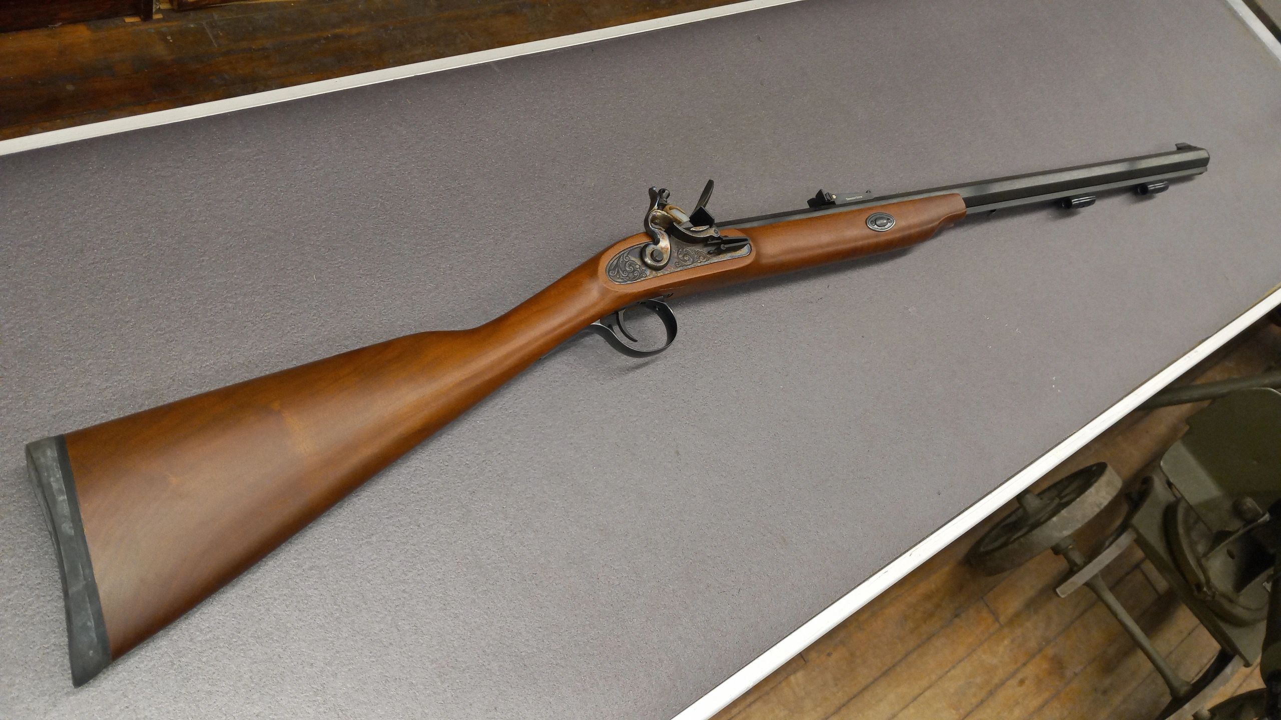 A vintage muzzleloader rifle with a wooden stock and metal barrel.
