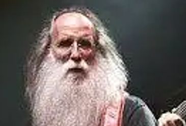Elderly man with a long white beard and glasses.