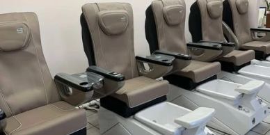 Row of pedicure spa chairs in a salon.