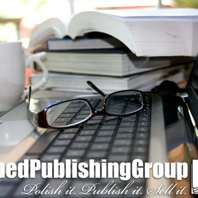 Reading glasses resting on a keyboard with stacked open books in the background.