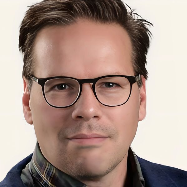 Portrait of a man wearing glasses and a plaid shirt.
