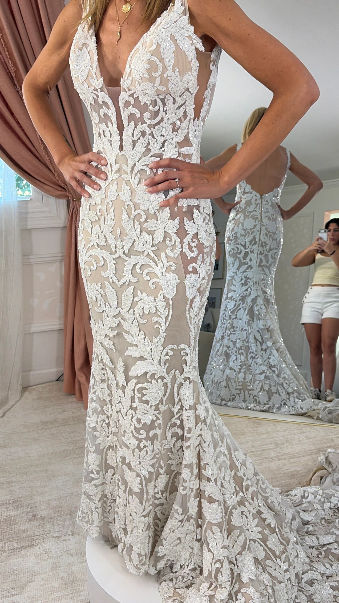 Elegant lace wedding dress with intricate floral detailing.