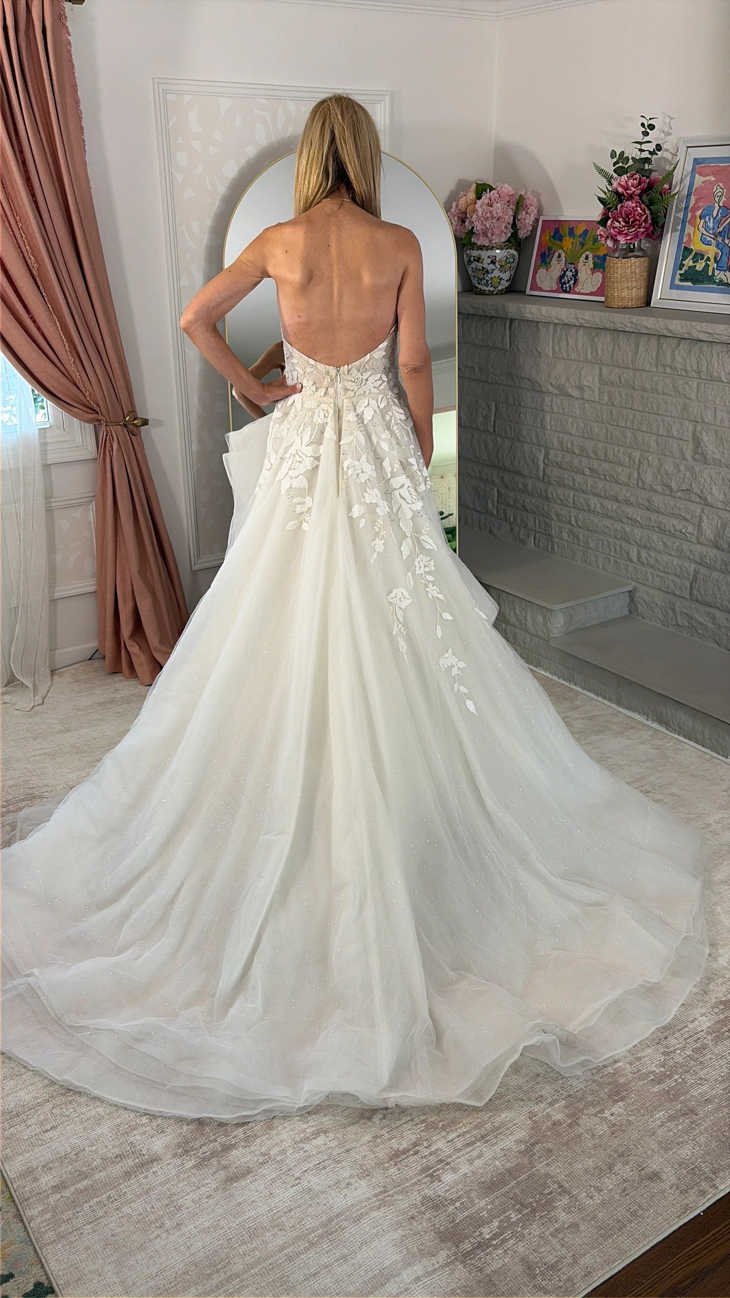 Bride in a backless wedding dress with a long train.