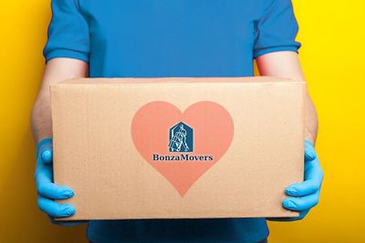A mover with protective gloves, the BonzaMovers logo in a heart
