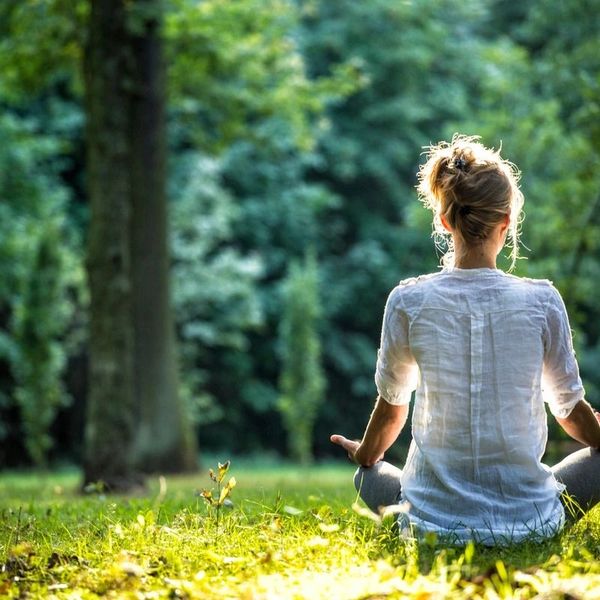 A relaxed person in a seated yoga pose