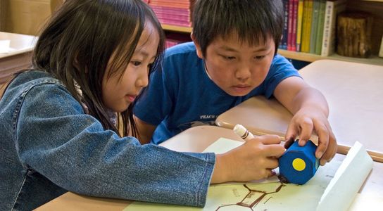 Elementary students draw shapes in Math class.