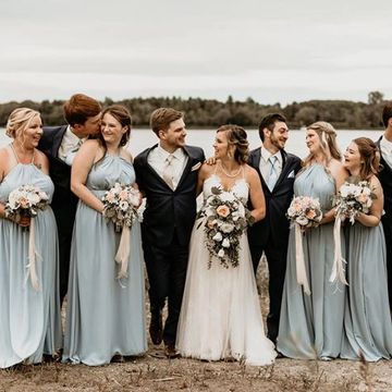 Bride and groom with wedding party. Bride is holding cascading wedding bouquet. London wedding flori