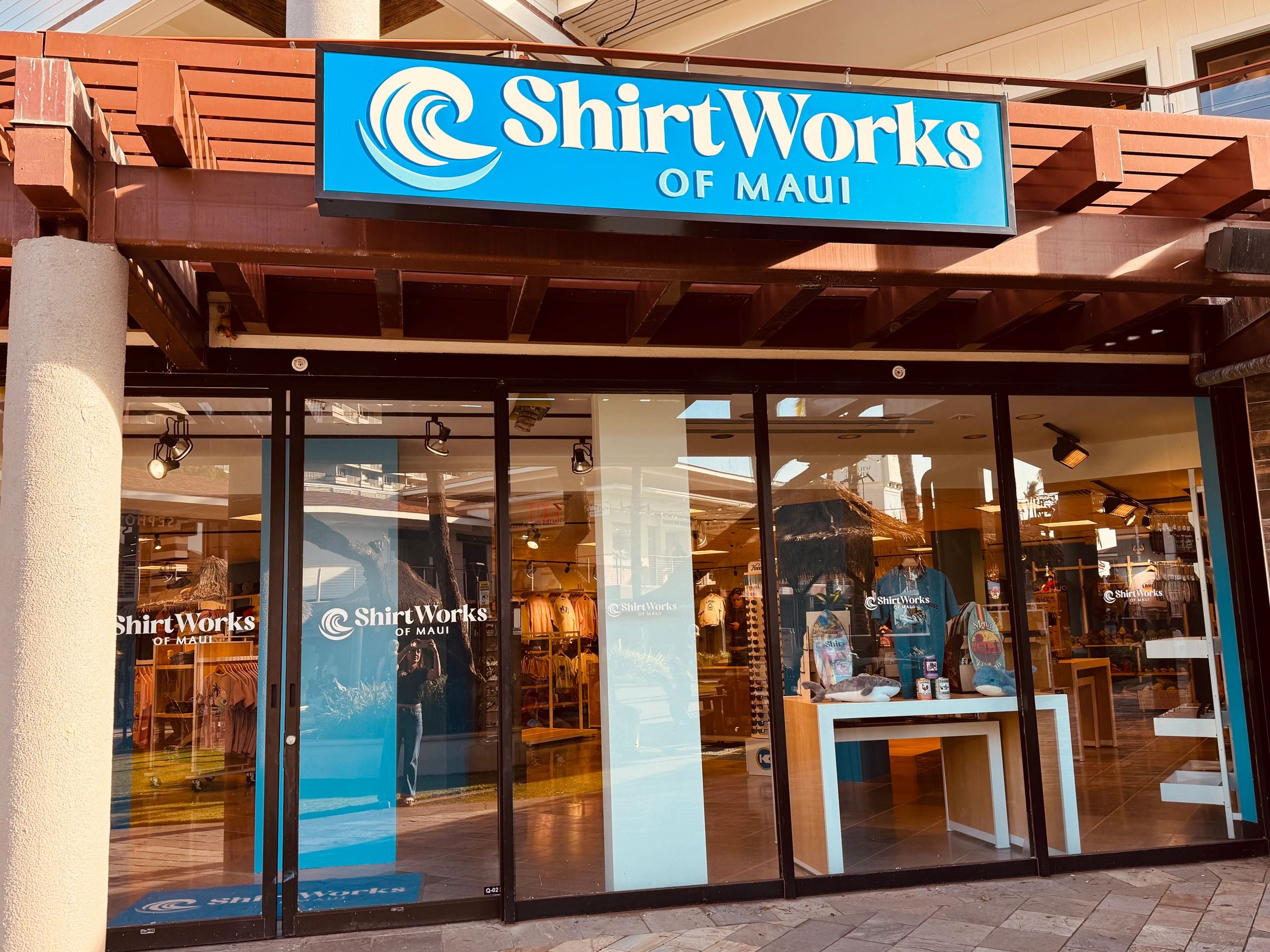 Stack of books next to pencils in a holder and a camera.