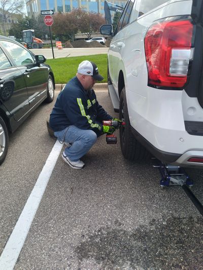  Man changing flat car tire