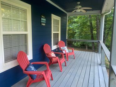 Enjoy the peaceful wooded views from the front porch of Cabin in the Heart of Pickwick 