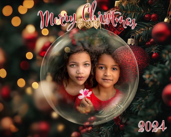 Two children inside a Christmas ornament with festive decorations.
