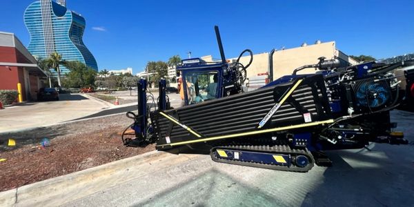 Trenchless utility install at McDonald's drive through.