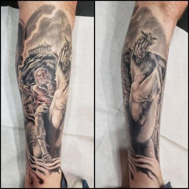 Detailed black and gray tattoo of a man and a horse on a forearm.