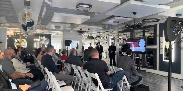 A group of people attending a presentation in a modern conference room.