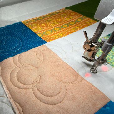 Longarm quilting machine quilting.