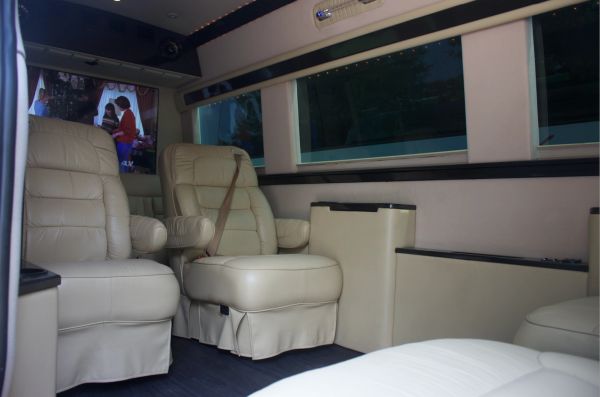Interior of a luxury vehicle with beige leather seats.