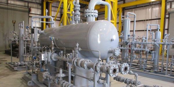Industrial equipment with pipes and valves inside a factory.