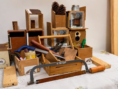 A collection of wooden boxes and tools arranged on a table.