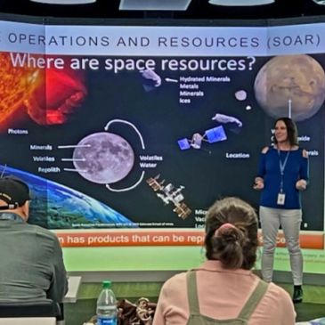 Woman presenting space resources in a classroom.