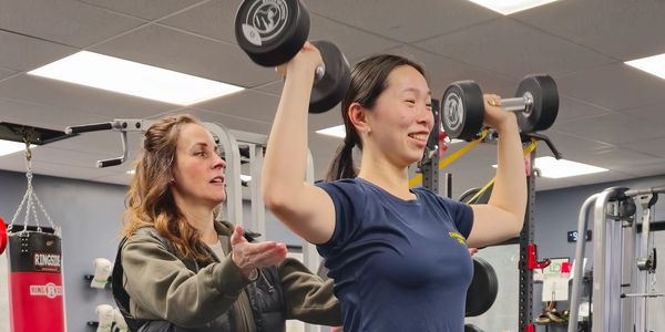 Trainer coaching a client during a private personal training session at LiV in St. Catharines