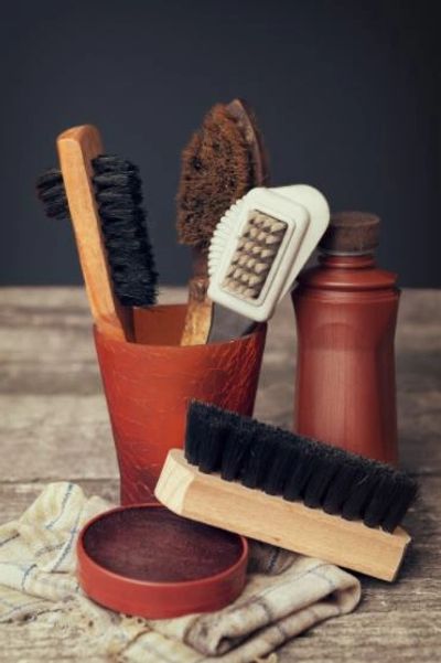 Leather Maintenance Brushes in pot on table.