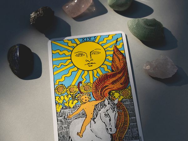 A tarot card with semi precious stones and crystals
