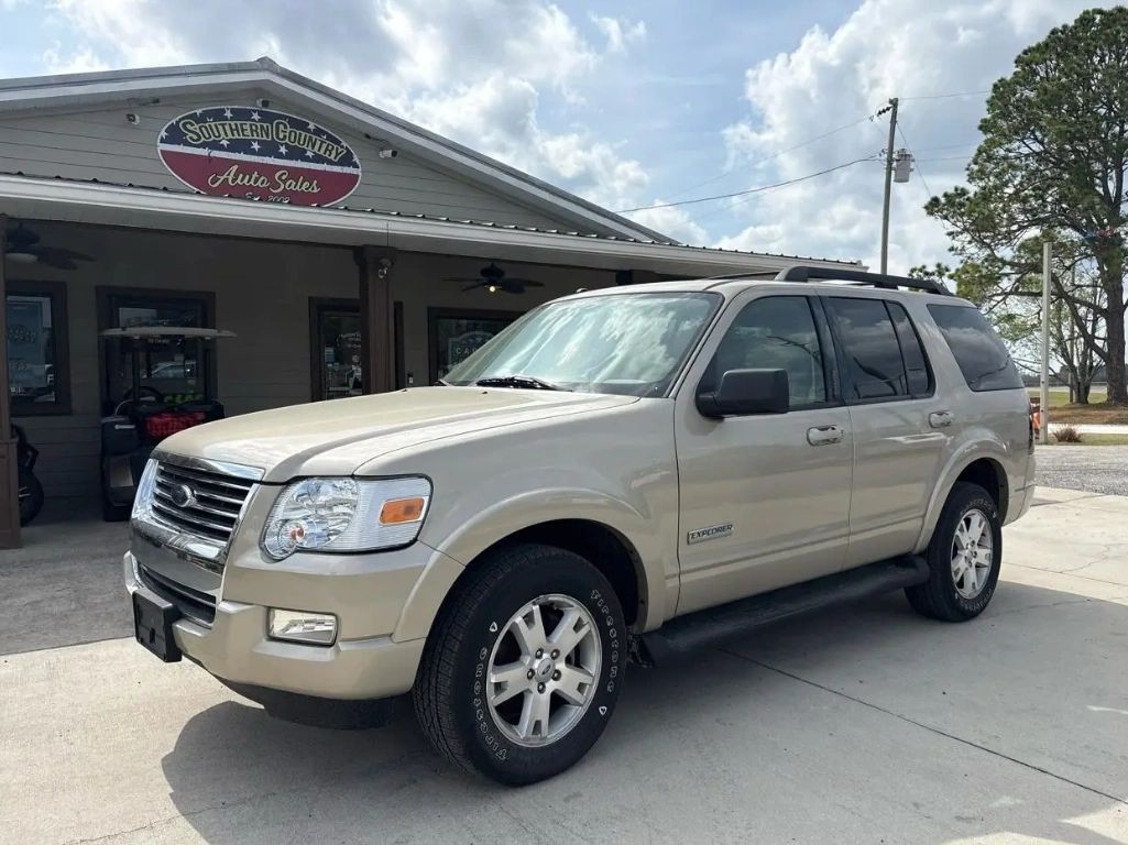 Beige Ford Explorer SUV parked outside Southern Country Auto Sales dealership.