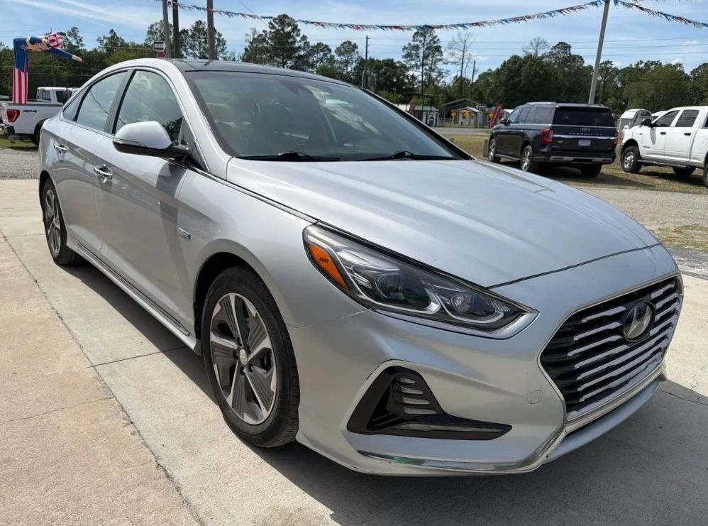 Silver Hyundai sedan parked outdoors on a sunny day.