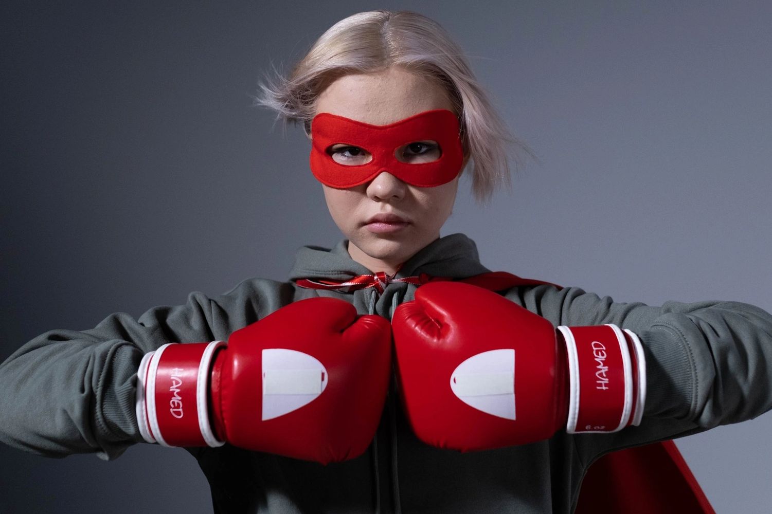 Girl superhero with boxing gloves representing conquering the autoimmune disorder Myasthenia Gravis