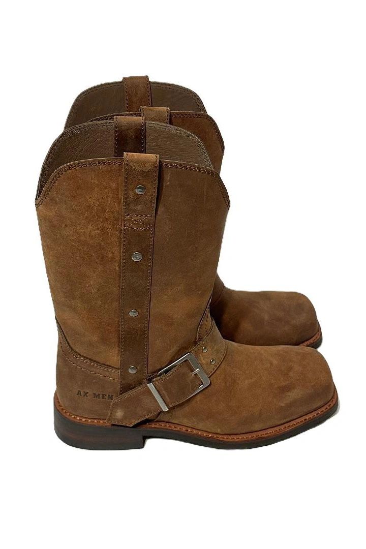 Brown leather boots with buckle detail and sturdy soles.
