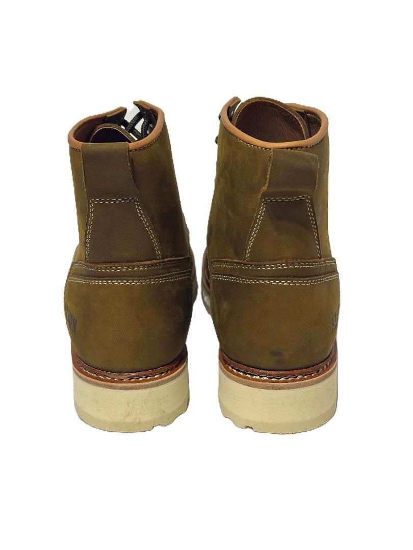 Rear view of brown leather boots with white soles and stitching detail.